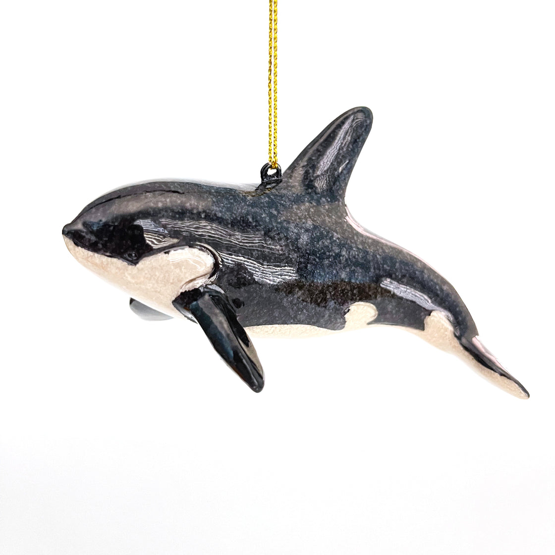 A hanging rengora Orca Killer Whale Christmas ornament set against a plain white backdrop
