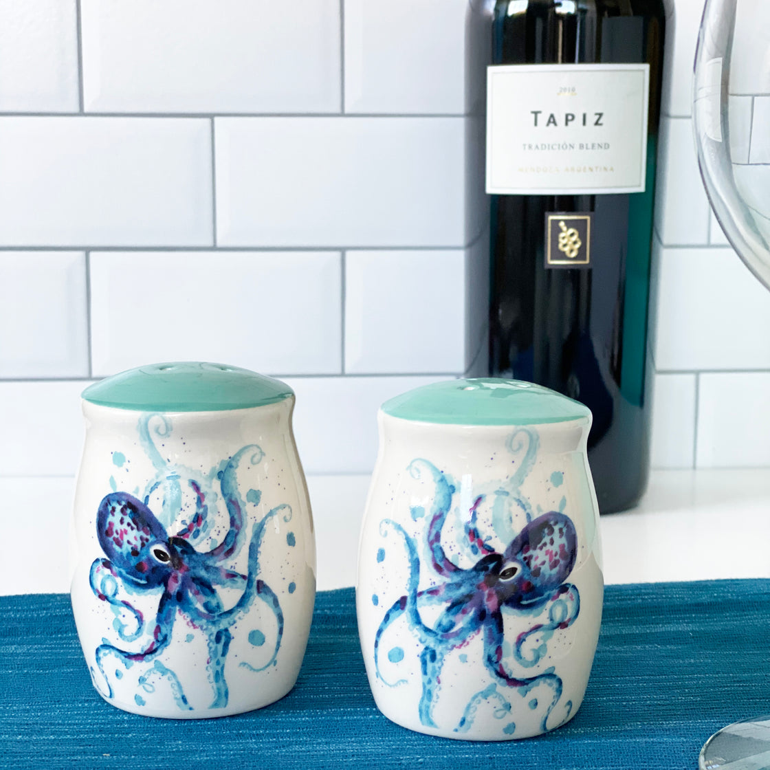 octopus salt n pepper shakers on blue runner with wine bottle in background