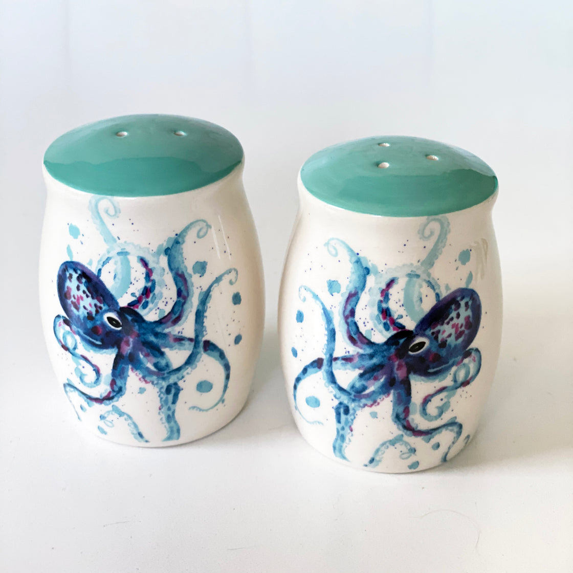 close up of octopus salt and pepper shakers on white background