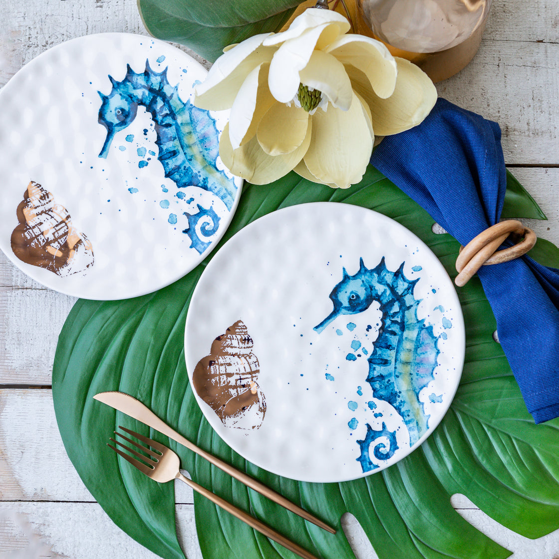 seahorse dessert plates on green leaf placemats on rustic table